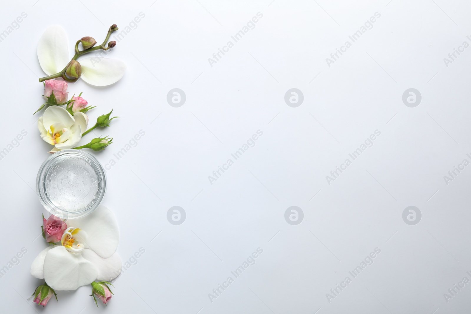 Photo of Composition with cosmetic gel and beautiful flowers on white background, top view