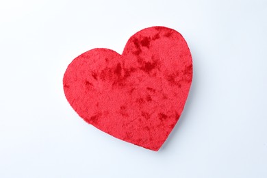 One velvet heart on white background, top view