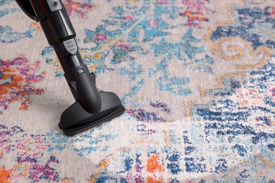 Image of Hoovering carpet with vacuum cleaner, closeup and space for text. Clean trace on dirty surface