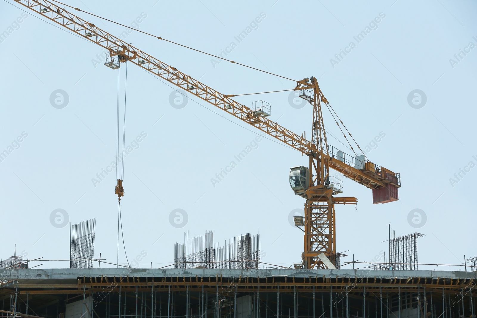 Photo of Construction crane and unfinished building, outdoors