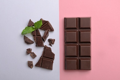 Photo of Flat lay composition with chocolate and mint on color background