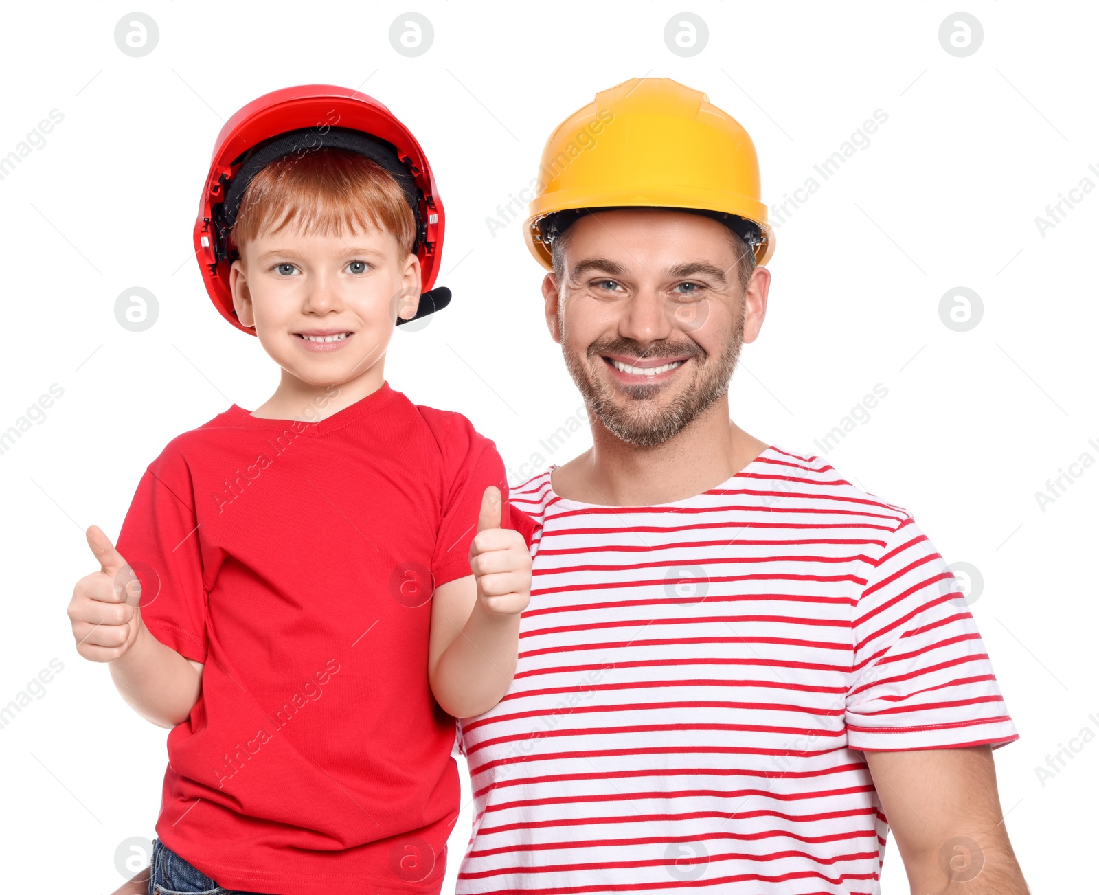 Photo of Happy father and son in hard hats showing thumbs up on white background. Repair work