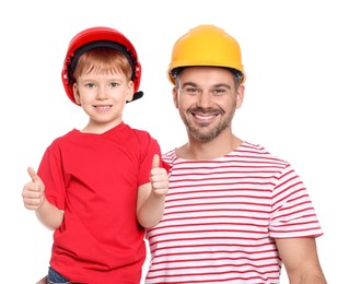 Happy father and son in hard hats showing thumbs up on white background. Repair work