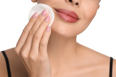 Photo of Beautiful woman removing makeup with cotton pad on white background, closeup