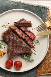 Photo of Delicious grilled beef steak served on table, top view