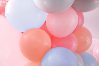 Beautiful colorful balloons on light background, closeup. Party decor 