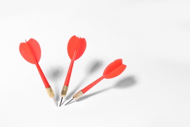 Photo of Red dart arrows for game on white background