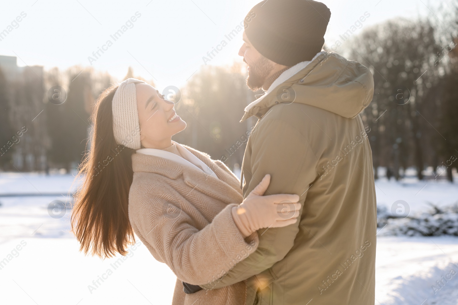 Photo of Beautiful happy couple in snowy park on winter day