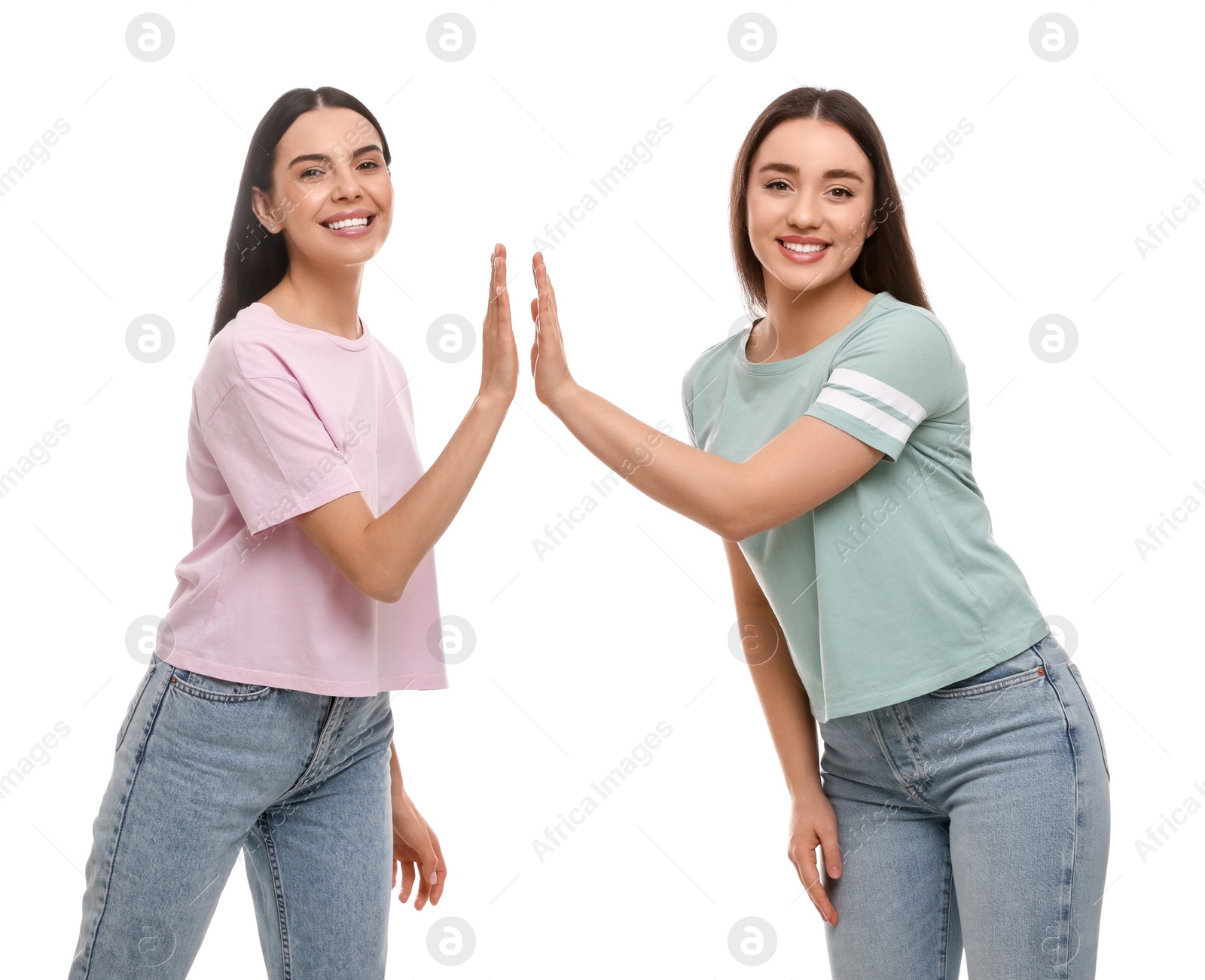 Photo of Women giving high five on white background