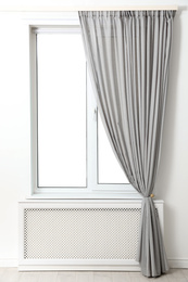 Photo of Modern window with beautiful curtains in room