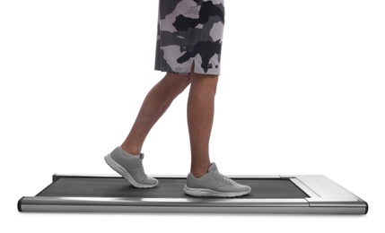 Man using walking treadmill on white background, closeup