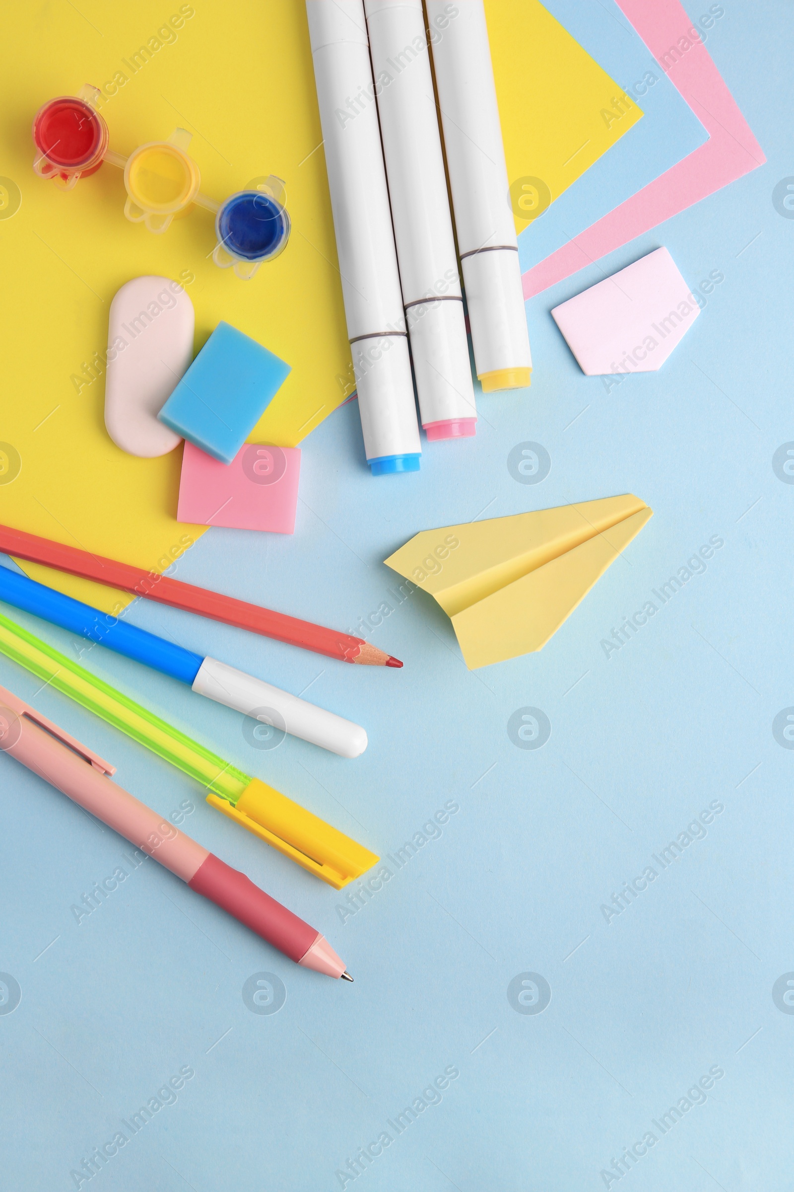 Photo of Flat lay composition with different school stationery on light blue background, space for text. Back to school