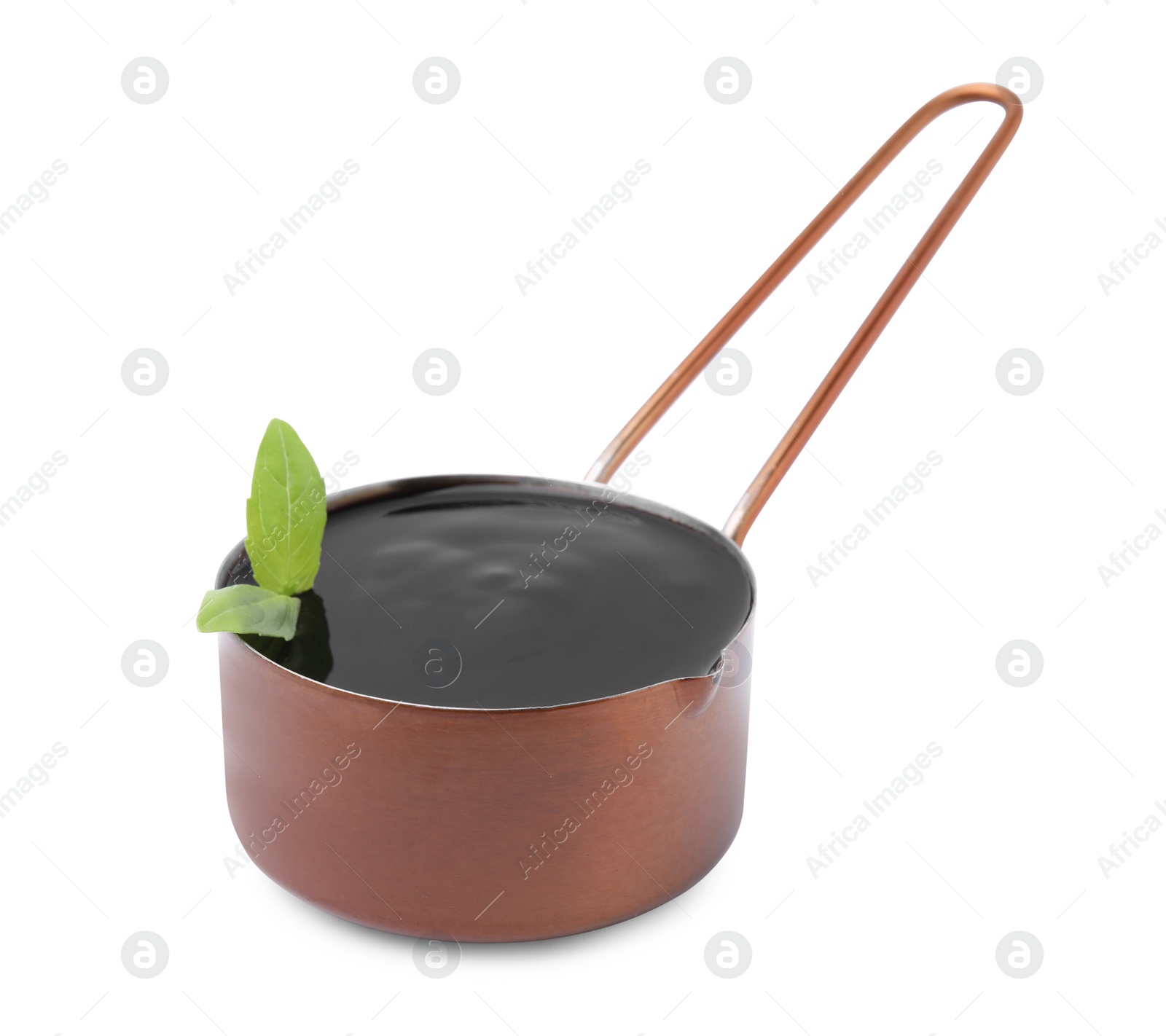 Photo of Balsamic glaze with basil leaves in metal small saucepan on white background