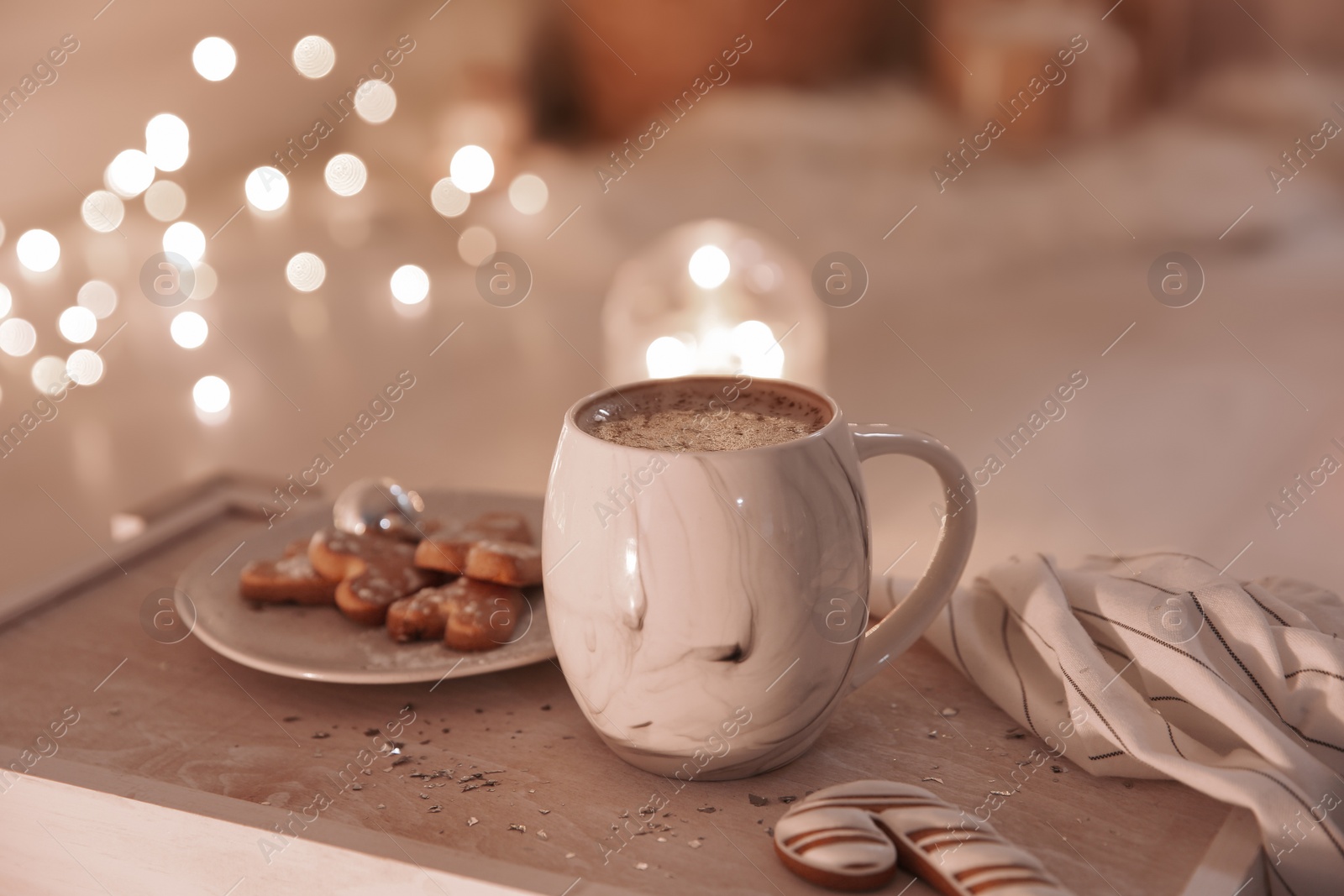 Photo of Cup of tasty hot drink and cookies on wooden table. Christmas atmosphere