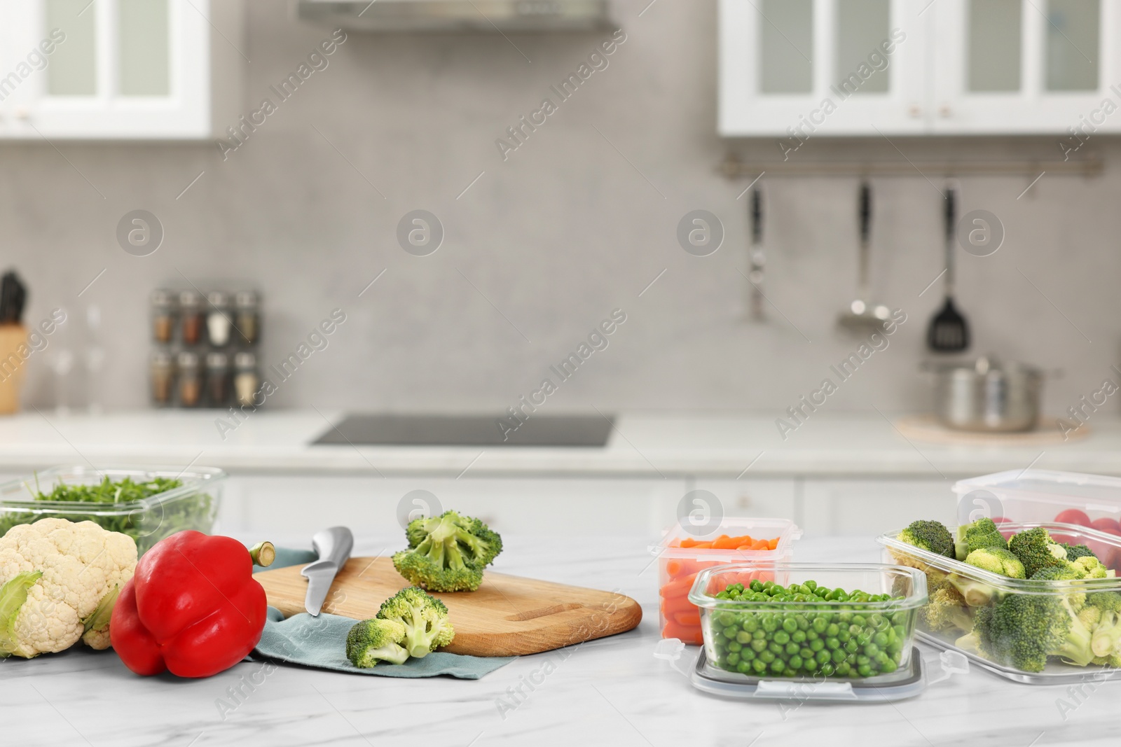 Photo of Glass and plastic containers with different fresh products on white marble table in kitchen, space for text