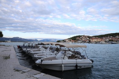 Trogir, Croatia - September 24, 2023: Picturesque view of mountains, town and moored boats in sea