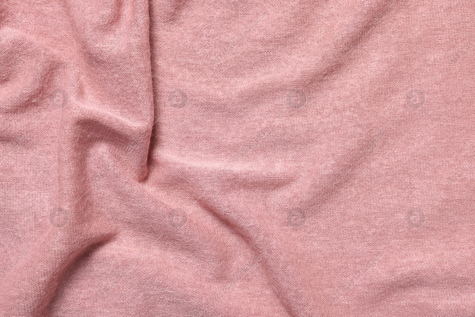 Photo of Texture of soft pink crumpled fabric as background, top view