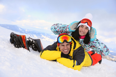 Lovely couple on snowy hill. Winter vacation