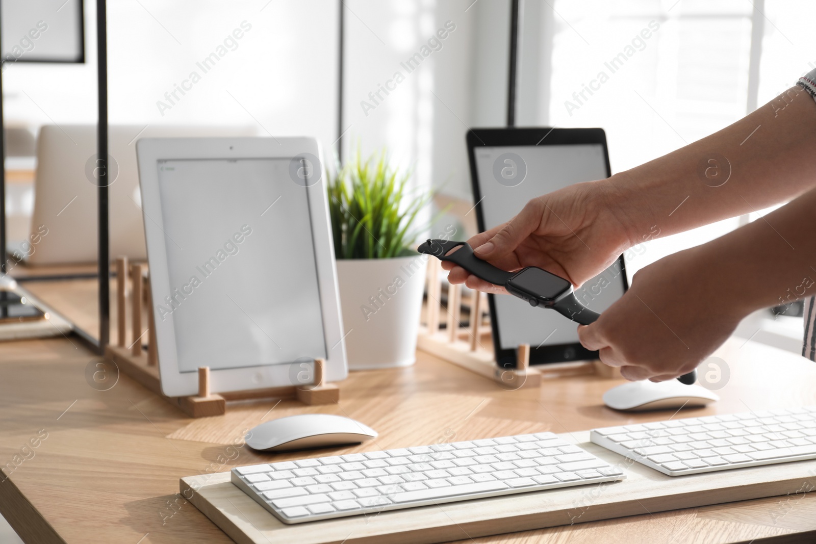 Photo of MYKOLAIV, UKRAINE - AUGUST 17, 2020: Woman choosing Smart Watch in Apple Store, closeup