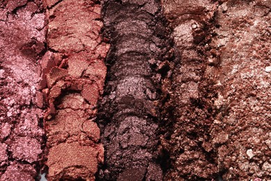 Photo of Different crushed eye shadows as background, top view. Professional makeup product