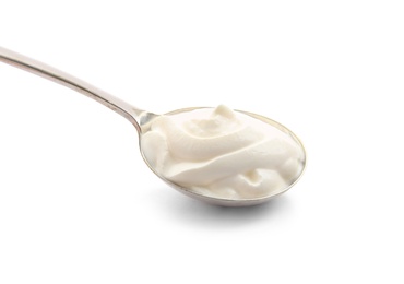 Metal spoon with sour cream on white background