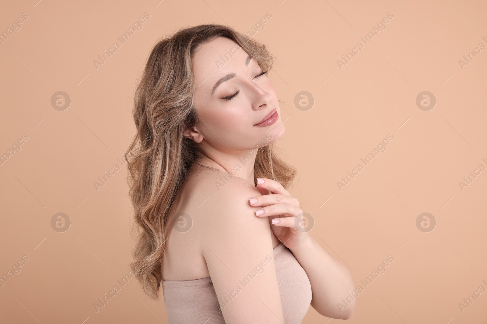 Photo of Portrait of beautiful woman on beige background