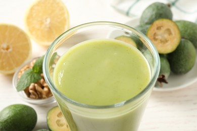 Photo of Freshly made feijoa smoothie in glass on light table, closeup