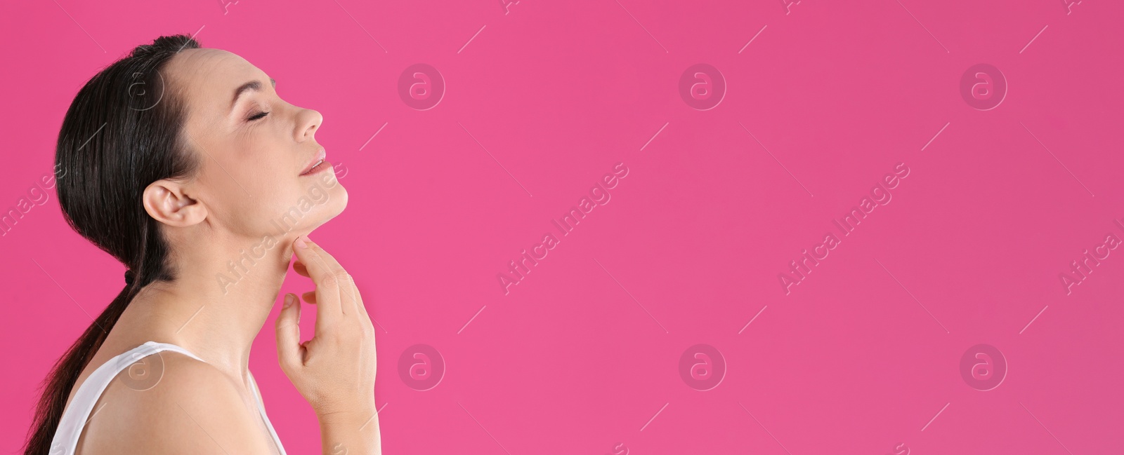 Image of Portrait of beautiful mature woman on pink background, space for text. Banner design