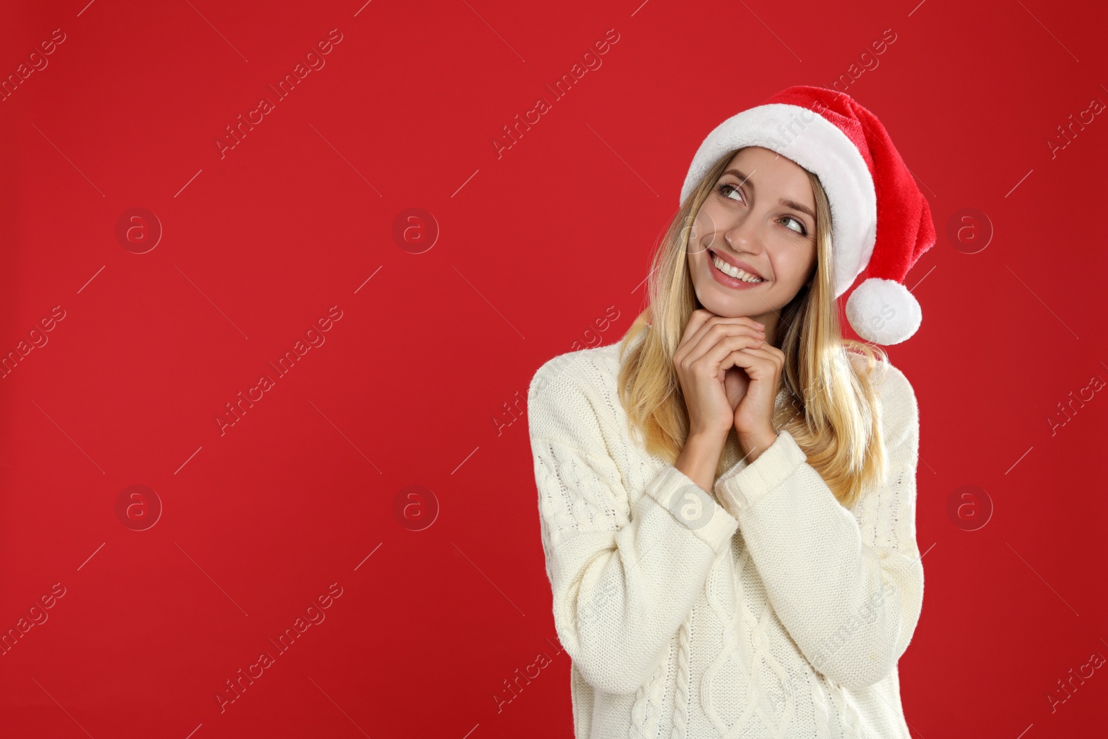 Photo of Happy woman in Santa hat on red background, space for text. Christmas countdown