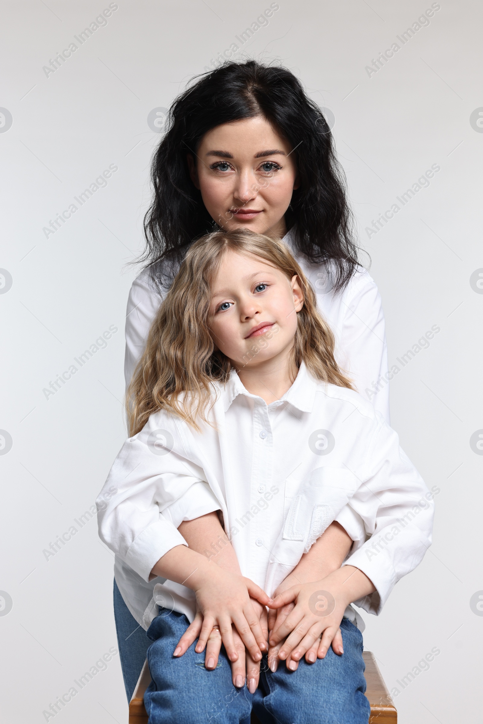 Photo of Beautiful mother with little daughter on white background