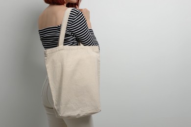 Woman with eco bag on white background, closeup