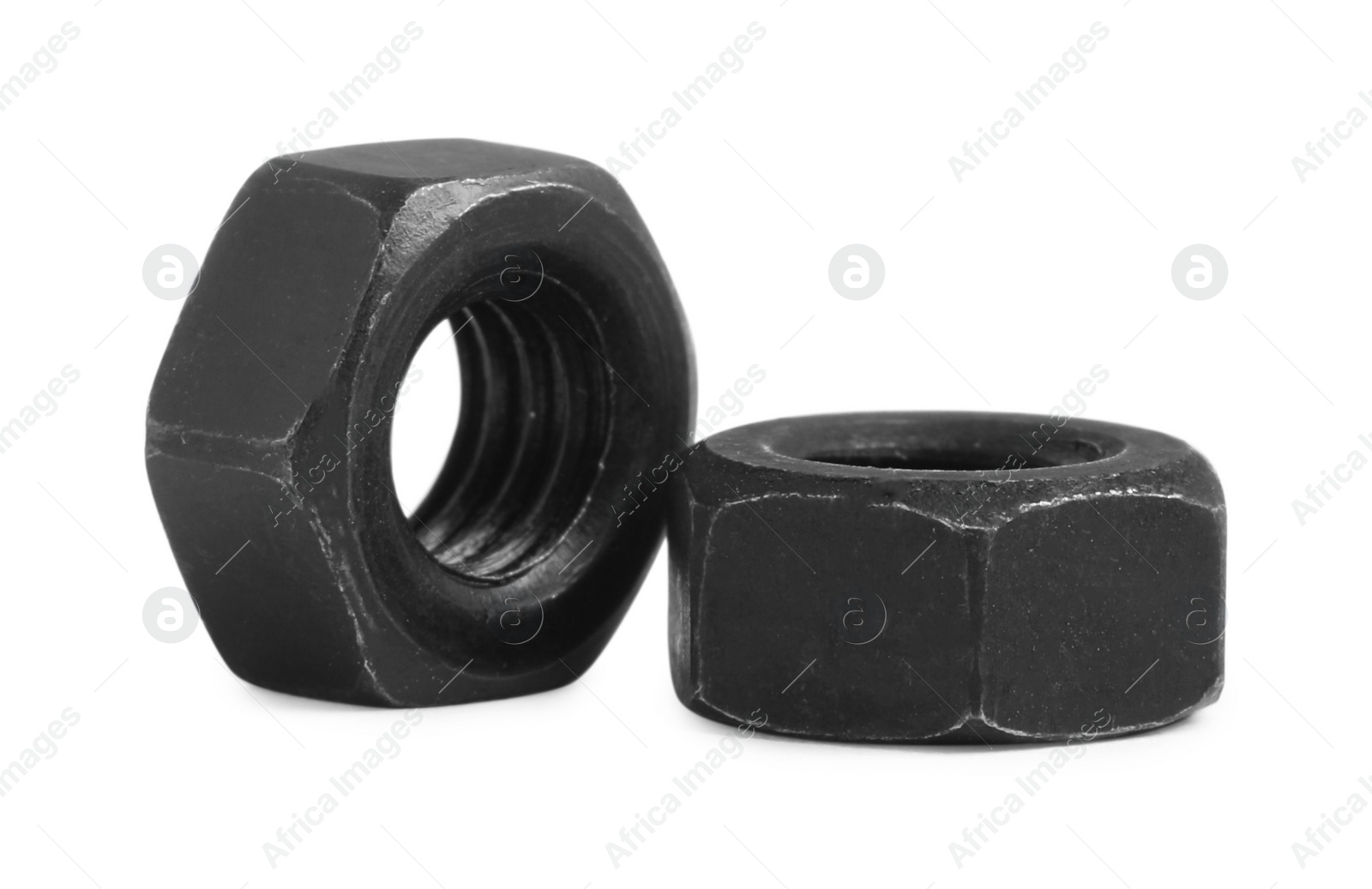 Photo of Two black metal hex nuts on white background