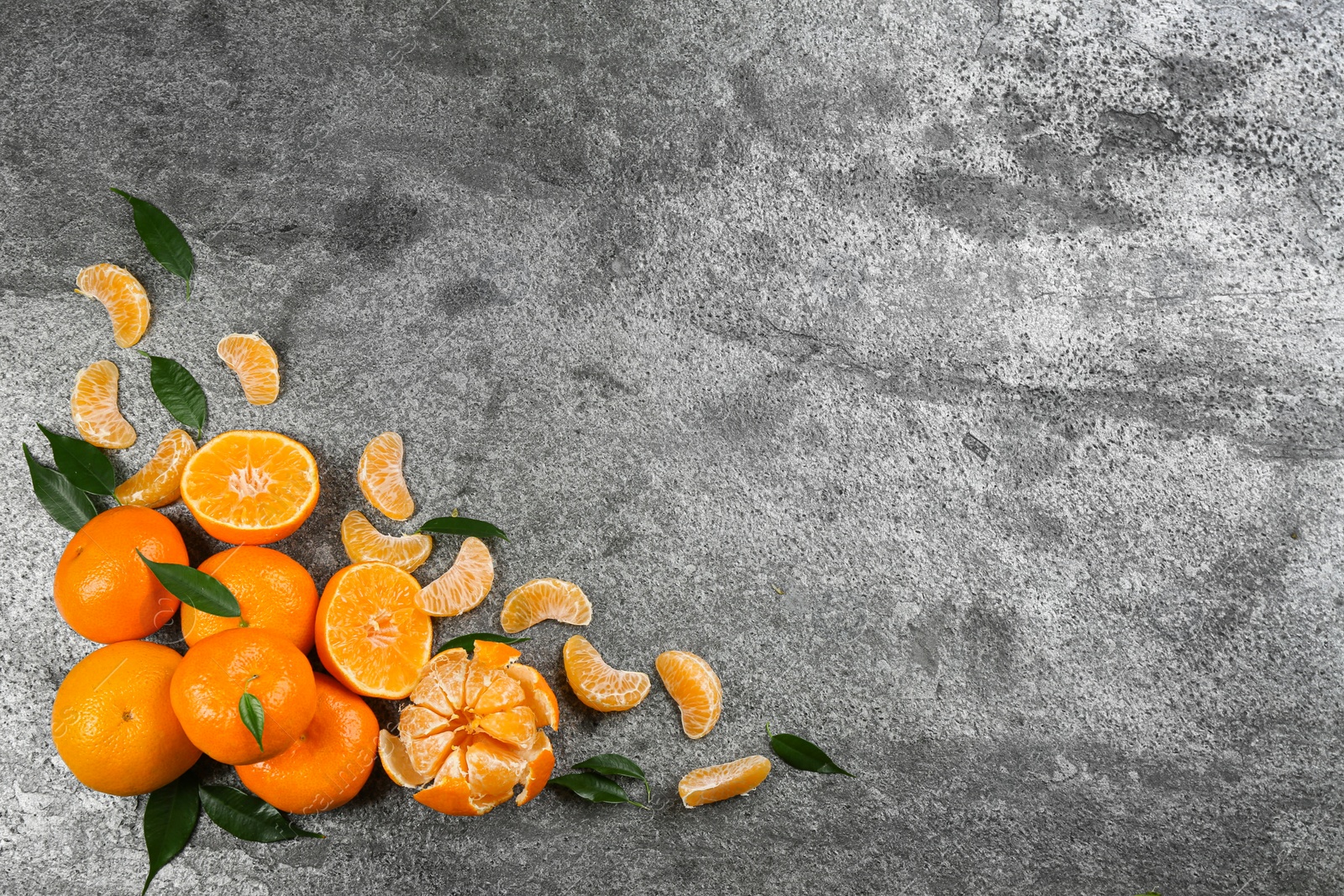 Photo of Flat lay composition with tangerines on grey background. Space for text