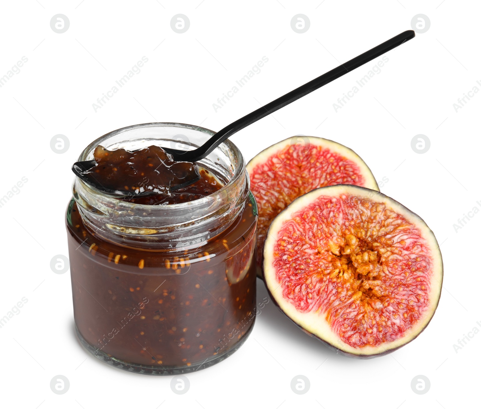 Photo of Glass jar of tasty sweet fig jam and spoon isolated on white