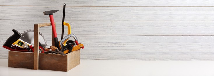 Image of Box with carpenter's tools on white table, space for text. Banner design