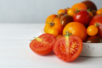 Photo of Fresh ripe tomatoes on white wooden table