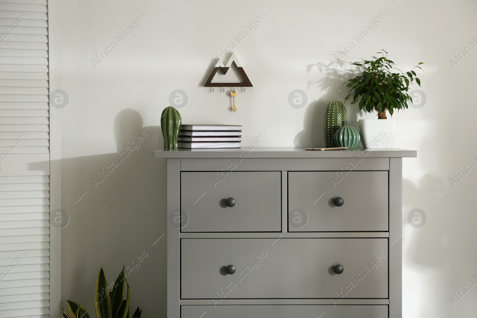 Photo of Grey chest of drawers in stylish room interior