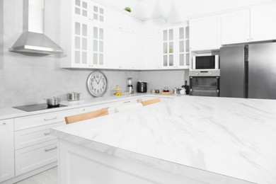 Stylish white marble table in kitchen. Interior design