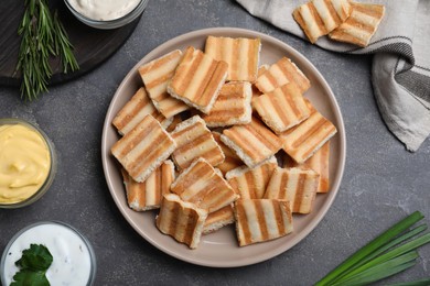 Delicious pita chips on grey table, flat lay