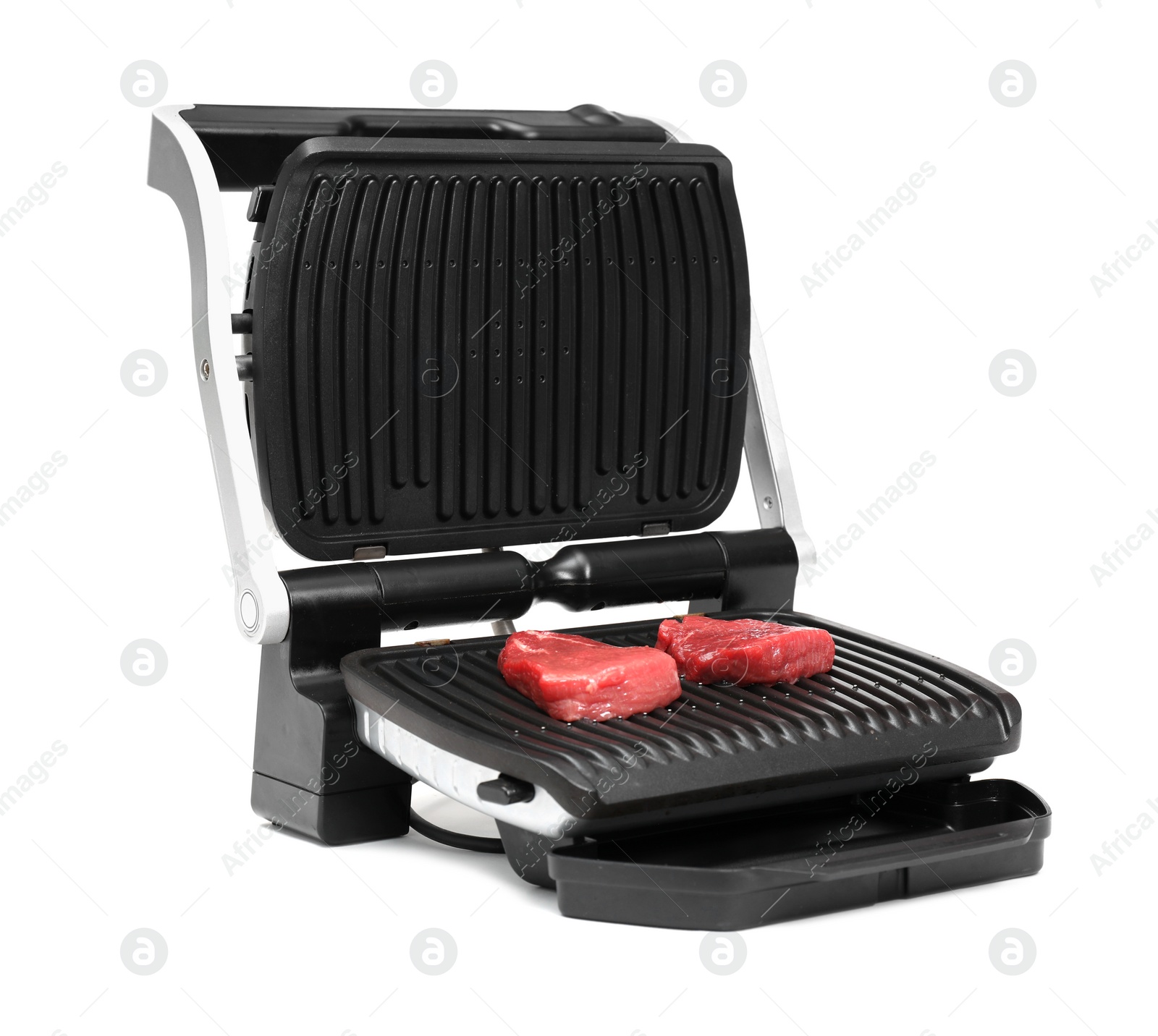 Photo of Electric grill with raw meat steaks isolated on white