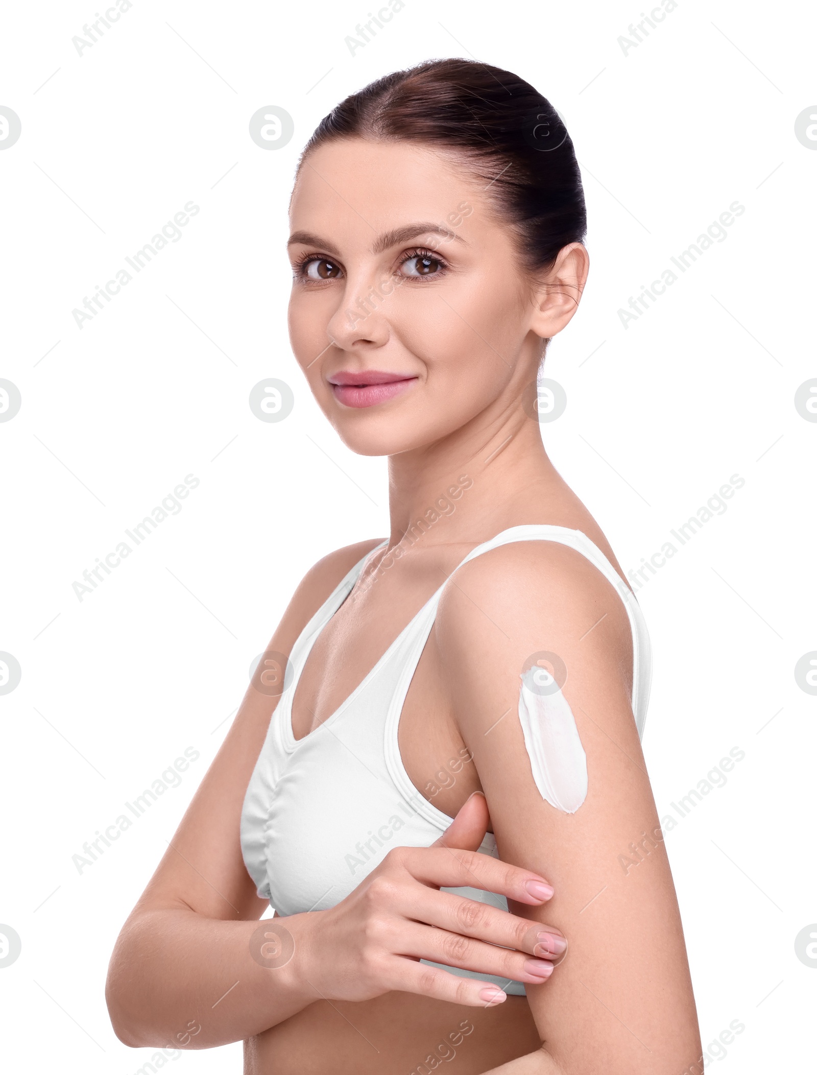 Photo of Beautiful woman with smear of body cream on her arm against white background