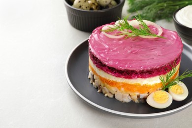 Photo of Herring under fur coat salad on light grey table, space for text. Traditional Russian dish