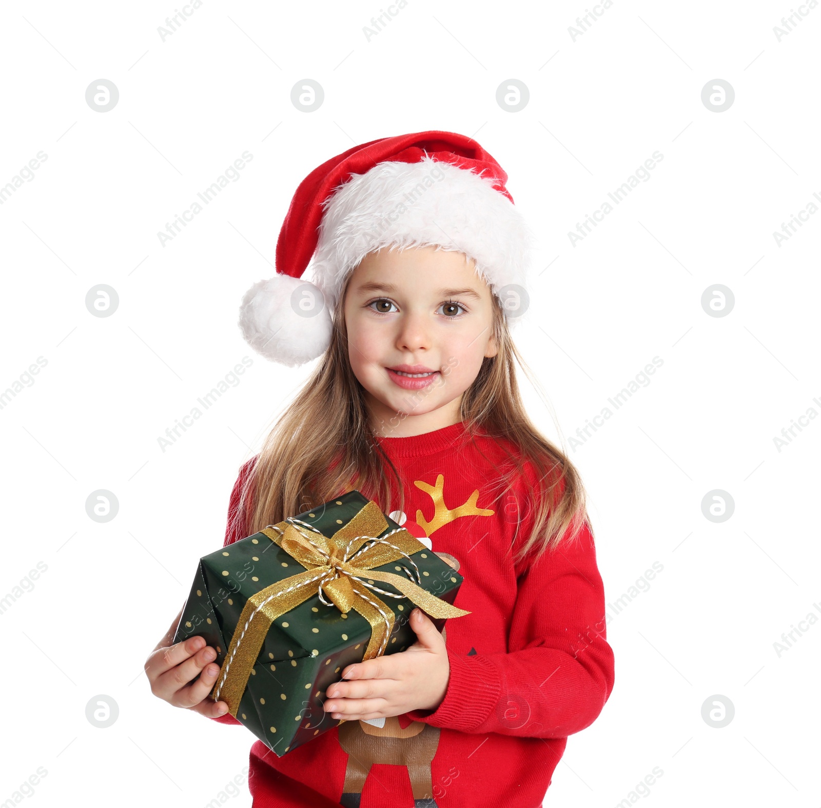 Photo of Cute child in Santa hat with Christmas gift on white background