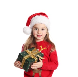 Photo of Cute child in Santa hat with Christmas gift on white background