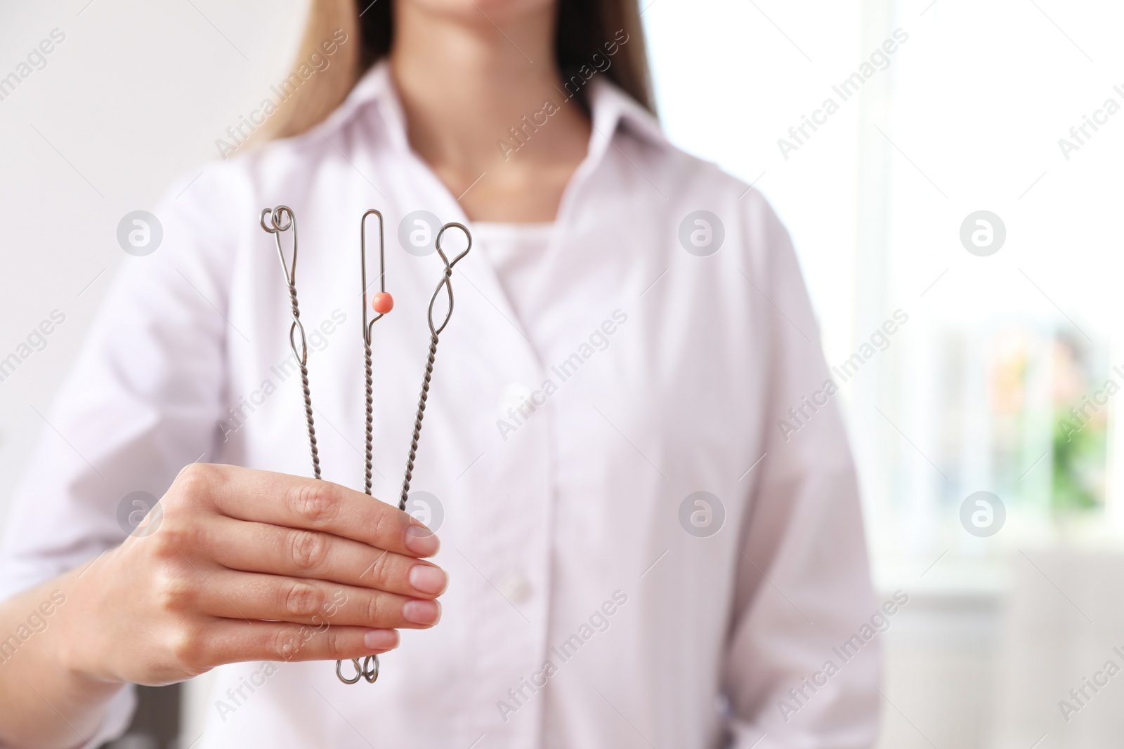 Photo of Speech therapist with logopedic probes in clinic, closeup. Space for text