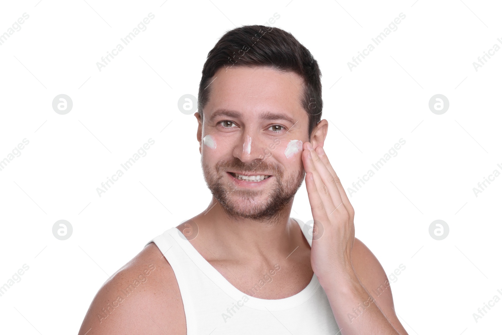 Photo of Man applying sun protection cream onto his face against white background