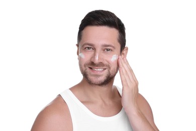 Photo of Man applying sun protection cream onto his face against white background