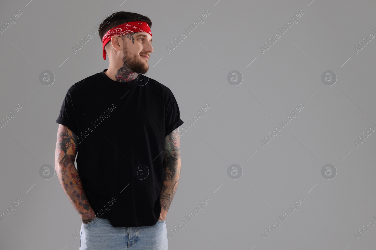 Photo of Handsome hipster man on light grey background. Space for text