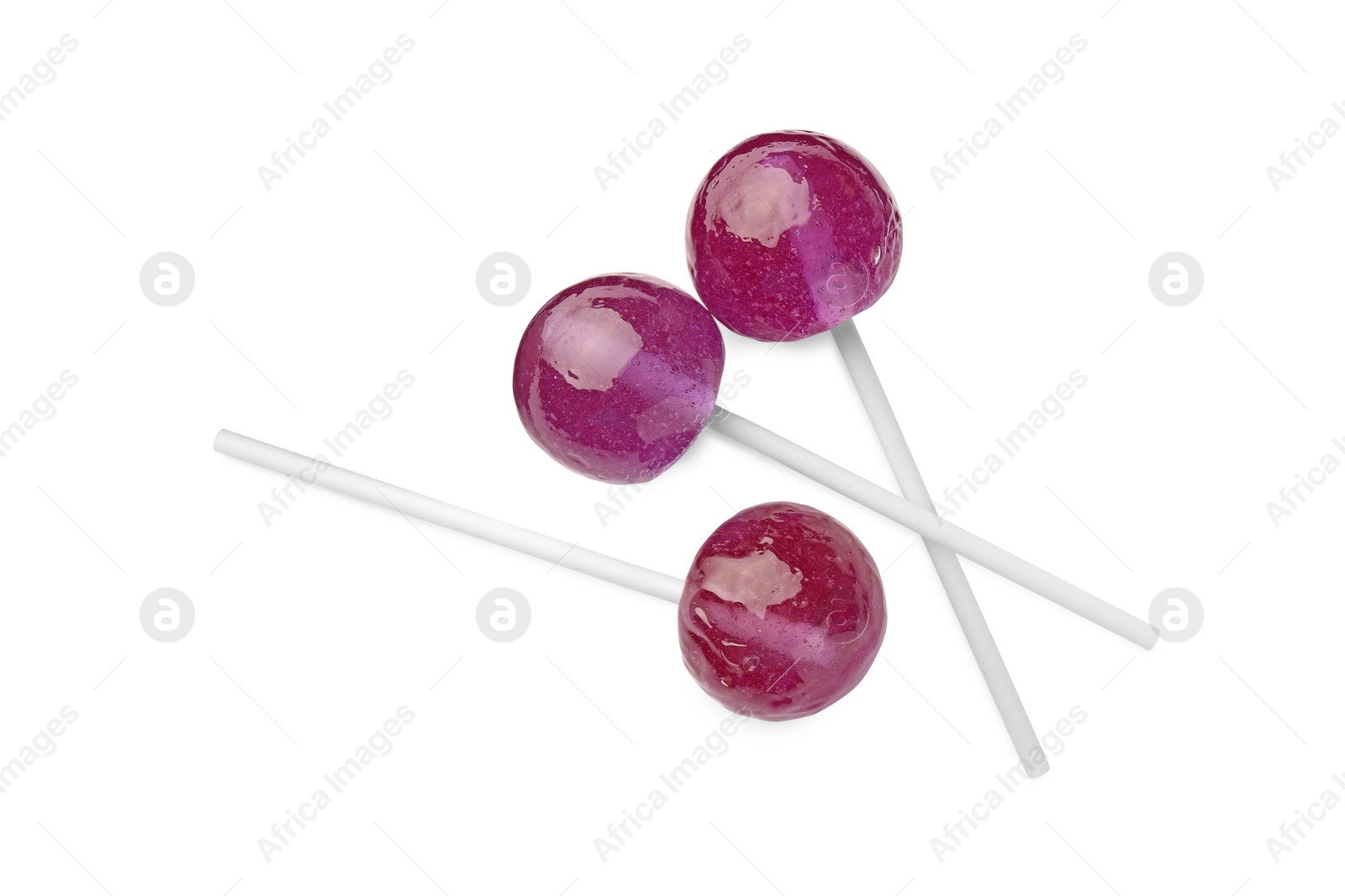 Photo of Many sweet purple lollipops isolated on white, top view