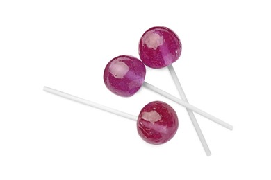 Photo of Many sweet purple lollipops isolated on white, top view